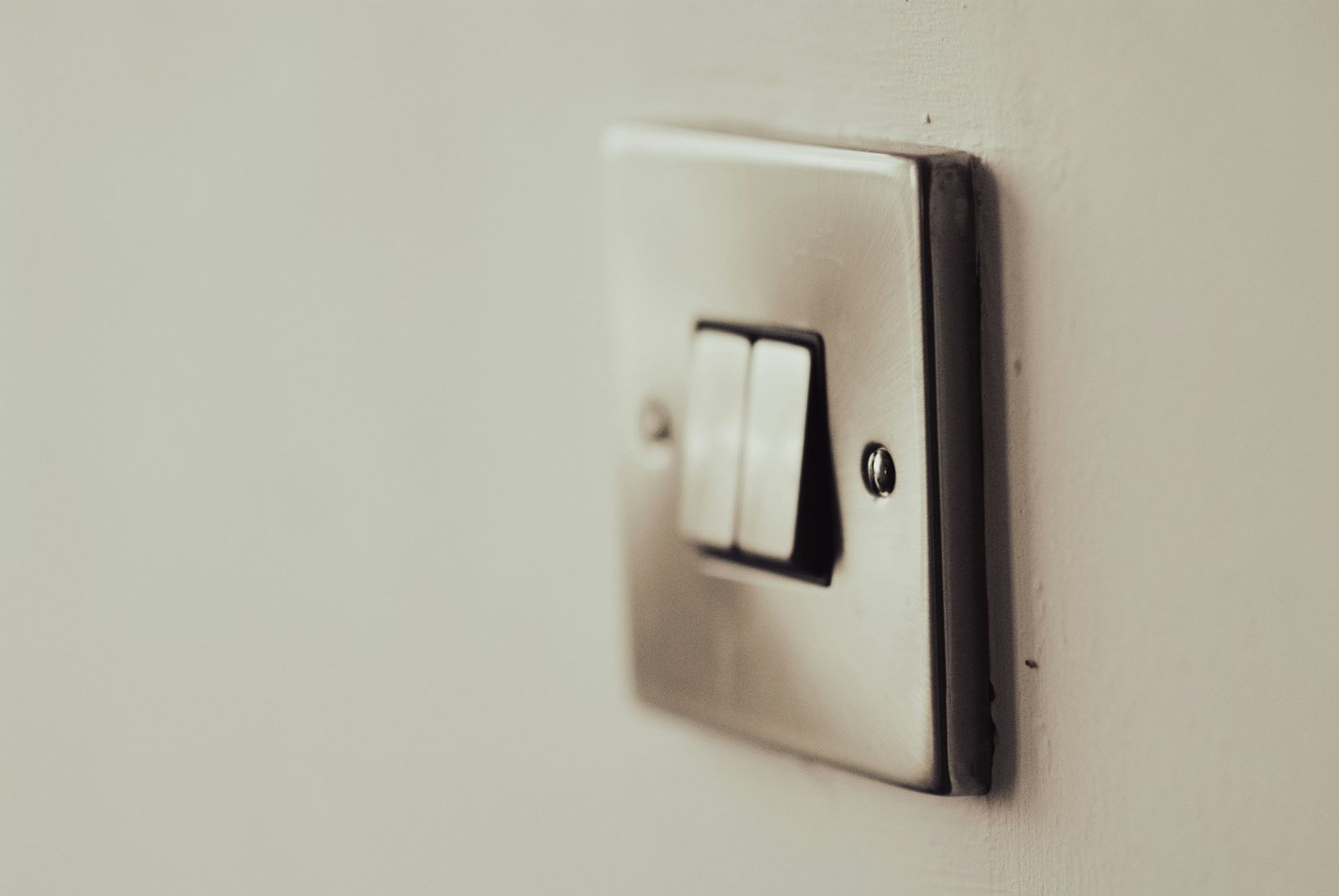 Double rocker light switch on a plain painted wall